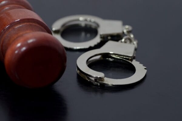 handcuffs and gavel on desk